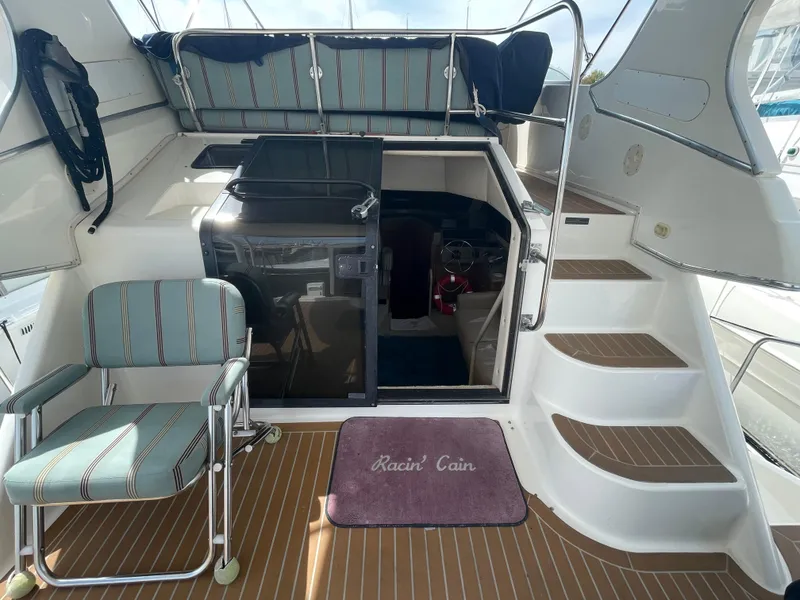 Slide: The Image of 1998 Bayliner 4087 Aft Cabin Motoryacht interior with striped seating and wooden flooring. - 28