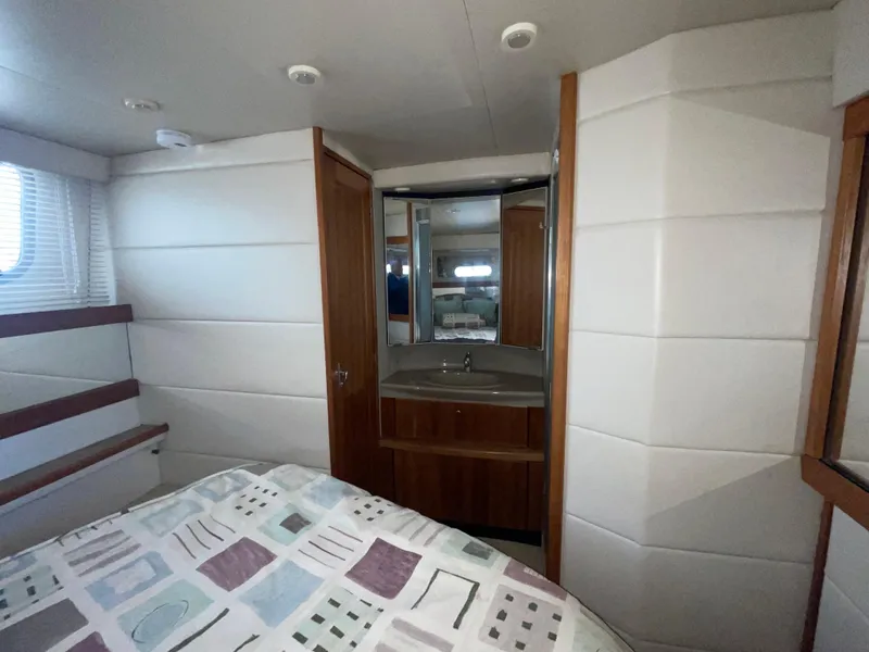 Slide: The Image of 1998 Bayliner 4087 Aft Cabin Motoryacht interior with bed, sink, and mirror. - 30