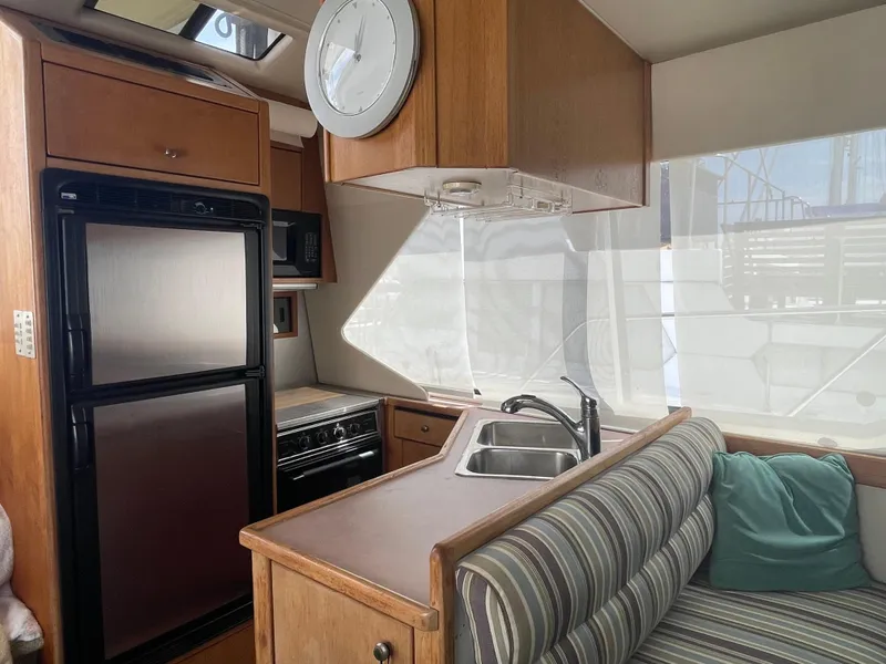 Slide: The Image of 1998 Bayliner 4087 Aft Cabin Motoryacht interior with kitchen and seating area. - 31