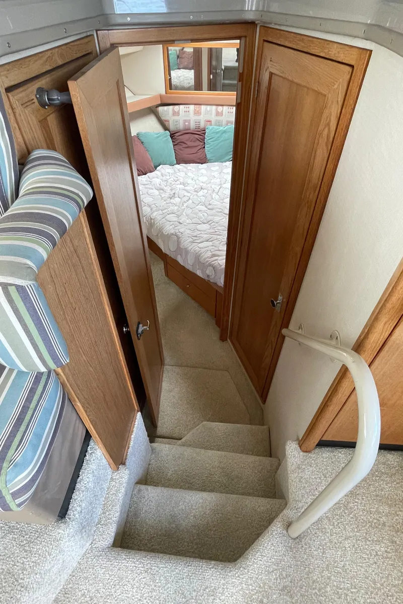 Slide: The Image of 1998 Bayliner 4087 Aft Cabin Motoryacht interior with stairs and cozy bedroom. - 33