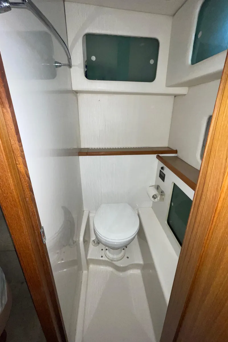 Slide: The Image of 1998 Bayliner 4087 Aft Cabin Motoryacht bathroom with toilet and storage shelves. - 35