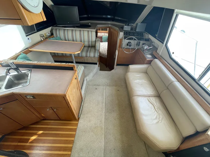 Slide: The Image of 1998 Bayliner 4087 Aft Cabin Motoryacht interior with kitchen, seating, and helm. - 7