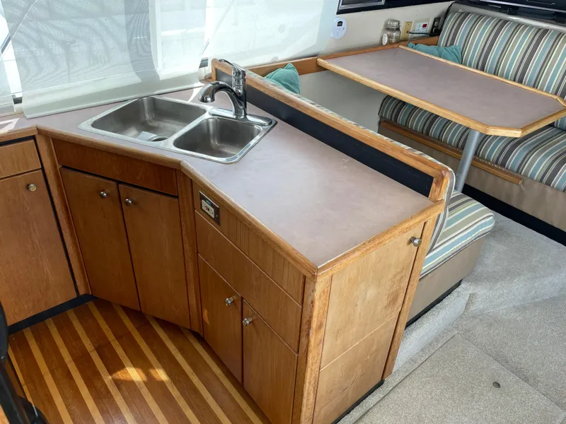 Slide: The Image of 1998 Bayliner 4087 Aft Cabin Motoryacht interior with kitchen and dining area. - 8