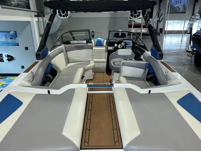 Slide: The Image of 2019 Tigé R23 boat interior with modern seating and dashboard in showroom. - 11