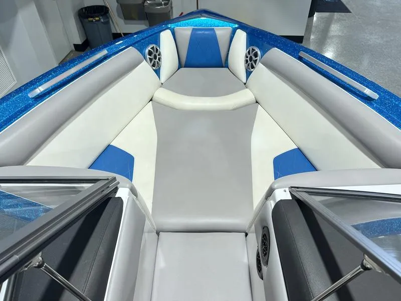 Slide: The Image of 2019 Tigé R23 boat interior with blue and gray seating, featuring speakers and sleek design. - 13