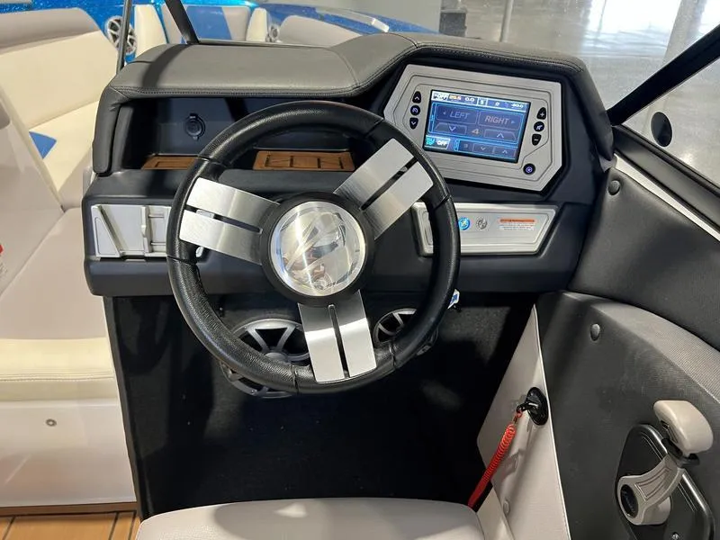 Slide: The Image of 2019 Tigé R23 boat dashboard with modern steering wheel and digital display. - 9
