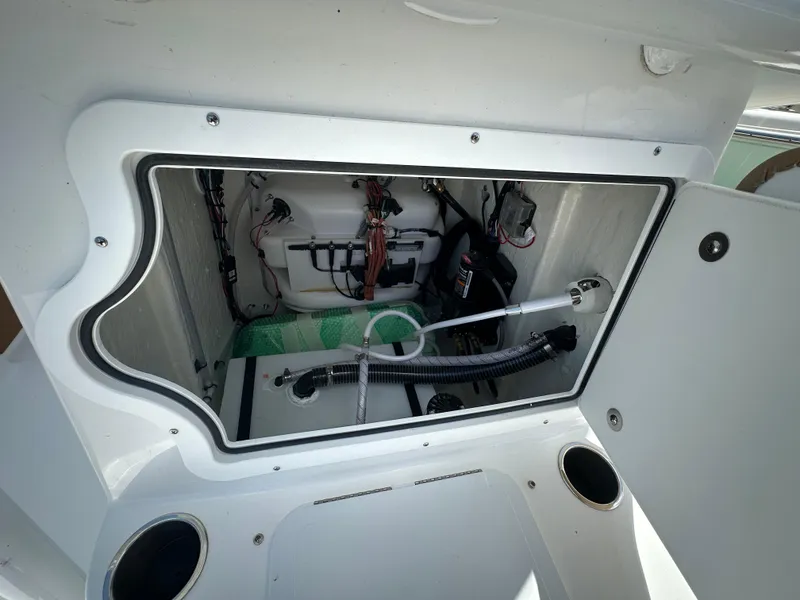 Slide: The Image of 2025 Sea Pro 230 Bay boat storage compartment with wiring and equipment. - 12