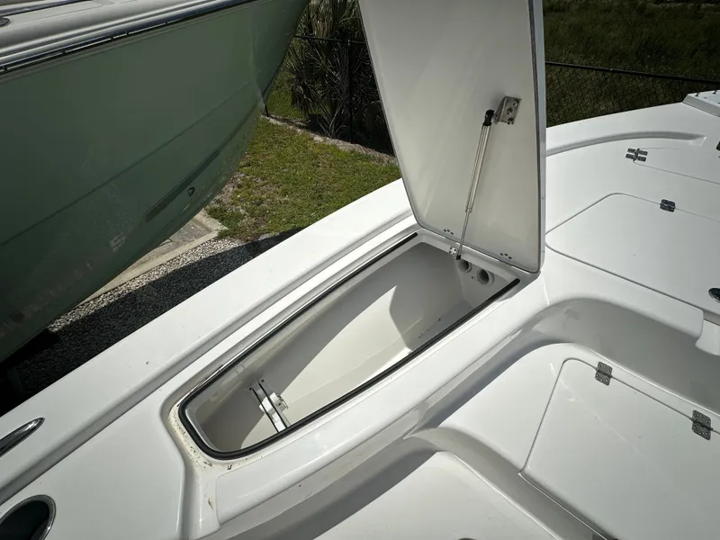 Slide: The Image of 2025 Sea Pro 230 Bay boat storage compartment open, showcasing spacious interior design. - 8