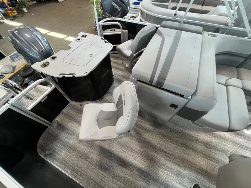 Slide: The Image of 2025 Bennington 22SXSAPG pontoon boat interior with gray seating and modern design. - 10