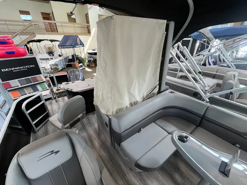Slide: The Image of 2025 Bennington 22SXSAPG pontoon boat interior with gray seating and modern design. - 11
