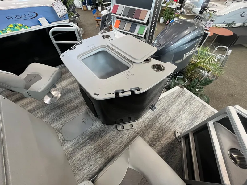 Slide: The Image of 2025 Bennington 22SXSAPG boat interior with seating, table, and Yamaha engine display. - 13