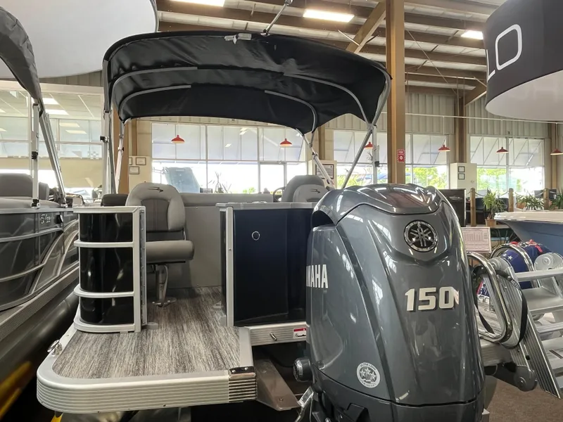 Slide: The Image of 2025 Bennington 22SXSAPG pontoon boat with Yamaha 150 engine in showroom. - 16