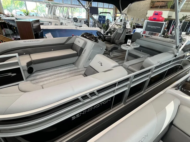 Slide: The Image of 2025 Bennington 22SXSAPG pontoon boat with sleek gray seating and modern design. - 2