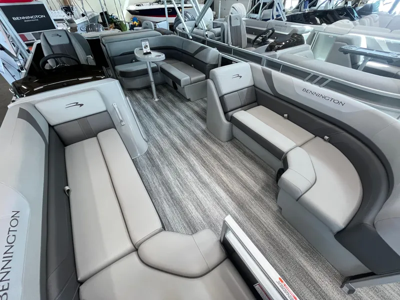 Slide: The Image of 2025 Bennington 22SXSAPG pontoon boat interior with luxurious gray seating and modern design. - 3