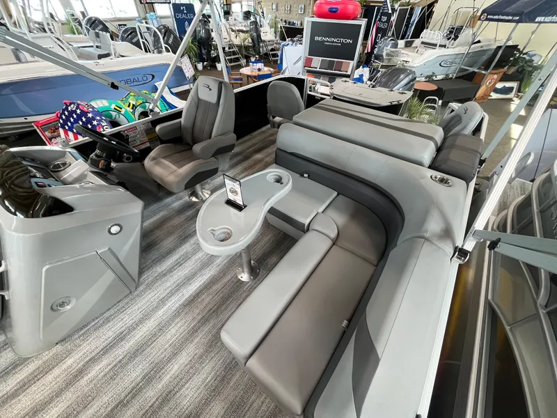 Slide: The Image of 2025 Bennington 22SXSAPG pontoon boat interior with gray seating and modern design. - 4