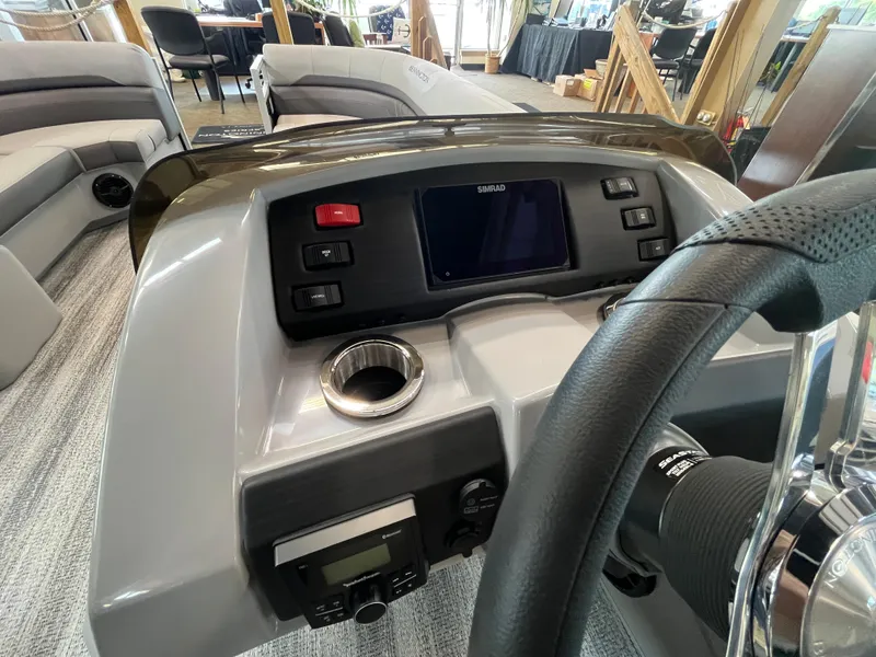 Slide: The Image of 2025 Bennington 22SXSAPG boat dashboard with steering wheel and control panel. - 5