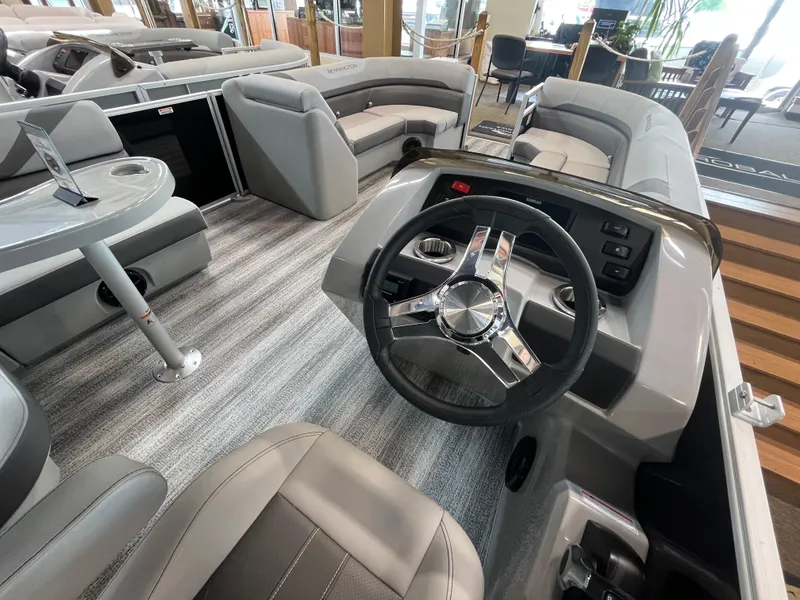 Slide: The Image of 2025 Bennington 22SXSAPG pontoon boat interior with modern steering and seating. - 6