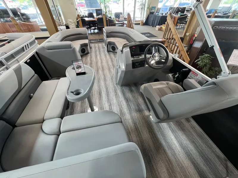 Slide: The Image of 2025 Bennington 22SXSAPG pontoon boat interior with plush seating and modern helm. - 7