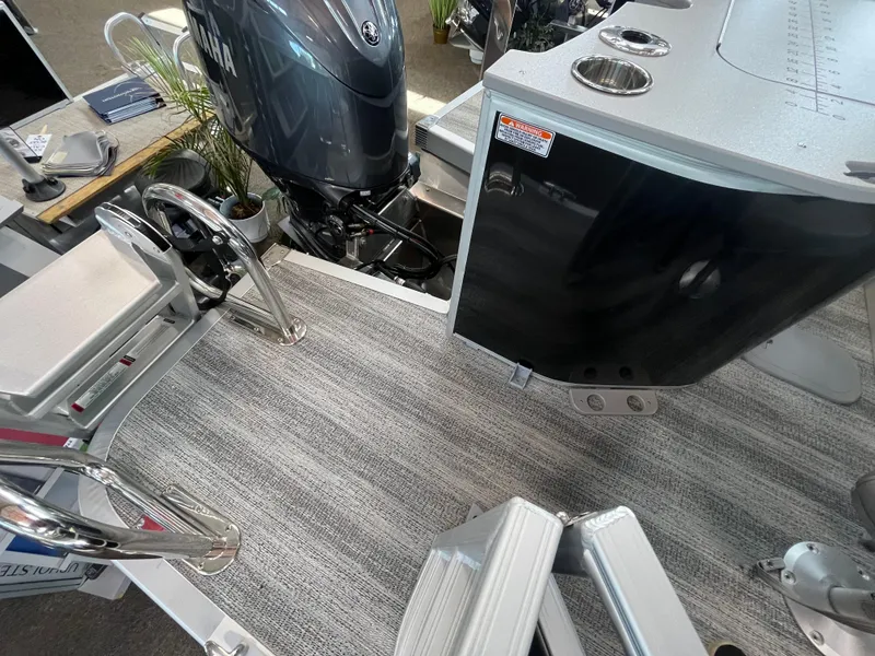Slide: The Image of 2025 Bennington 22SXSAPG boat interior with motor, ladder, and seating area. - 9