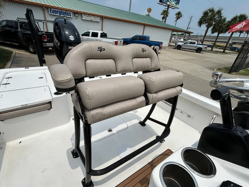 Slide: The Image of 2020 Sea Pro 228 Bay boat with cushioned seating and cup holders, parked outdoors. - 15