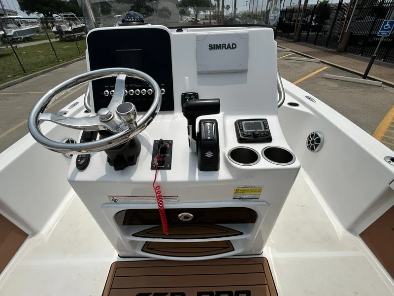 Slide: The Image of 2020 Sea Pro 228 Bay boat console with steering wheel and Simrad electronics. - 16