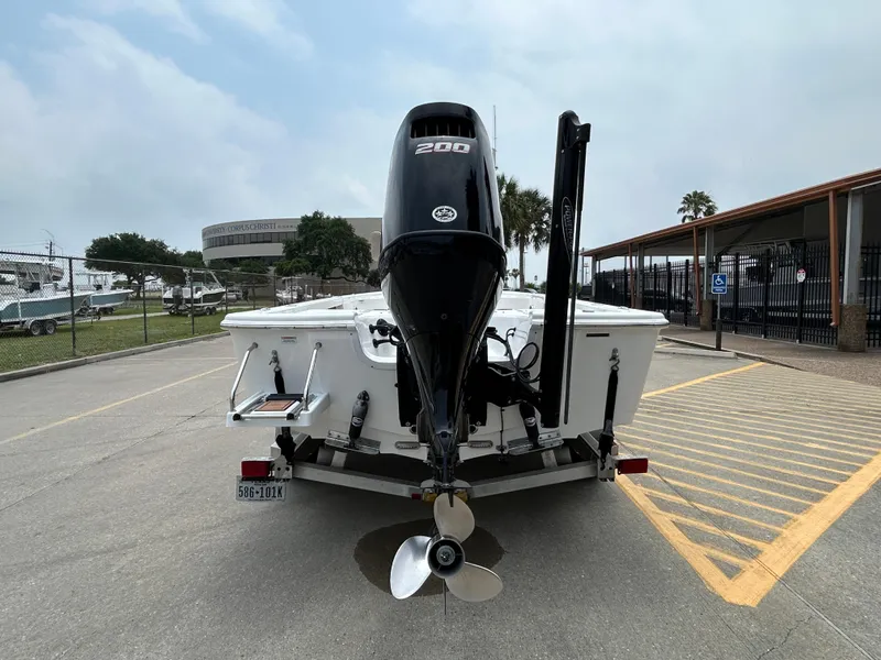 Slide: The Image of 2020 Sea Pro 228 Bay boat with powerful outboard motor, parked in a marina lot. - 2