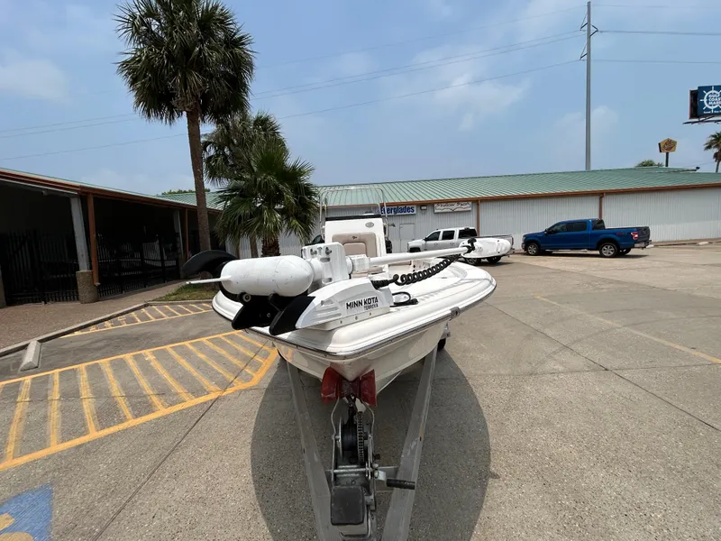 Slide: The Image of 2020 Sea Pro 228 Bay boat on trailer in parking lot, palm trees in background. - 6