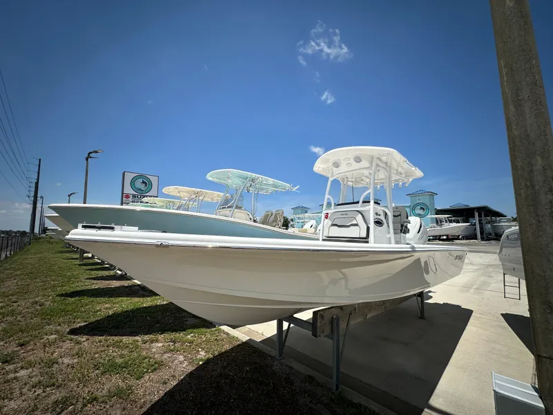 The Image of 2025 Sea Pro 250 Bay boat displayed outdoors under clear blue sky. - 1