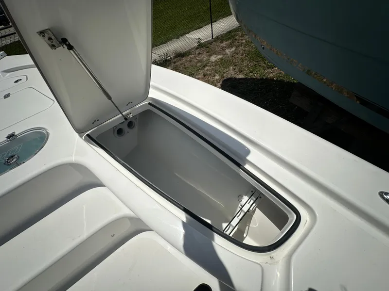 Slide: The Image of Open storage compartment on 2025 Sea Pro 250 Bay boat deck. - 10