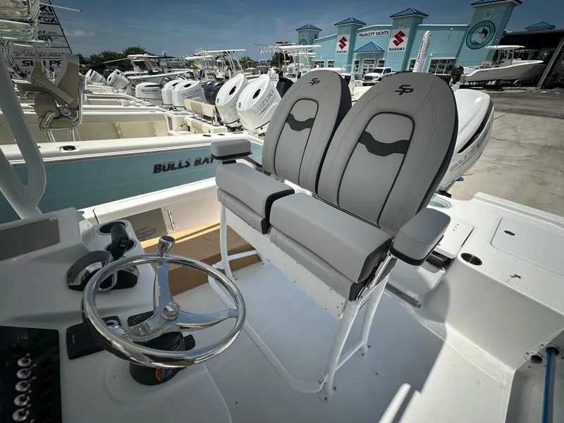Slide: The Image of 2025 Sea Pro 250 Bay boat interior with dual seats and steering wheel. - 13