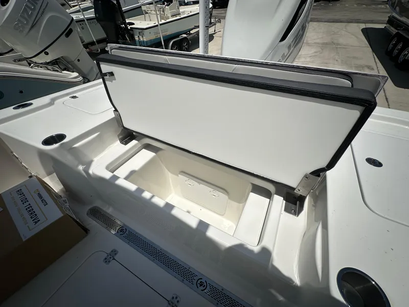 Slide: The Image of 2025 Sea Pro 250 Bay boat storage compartment open, showcasing spacious interior design. - 14