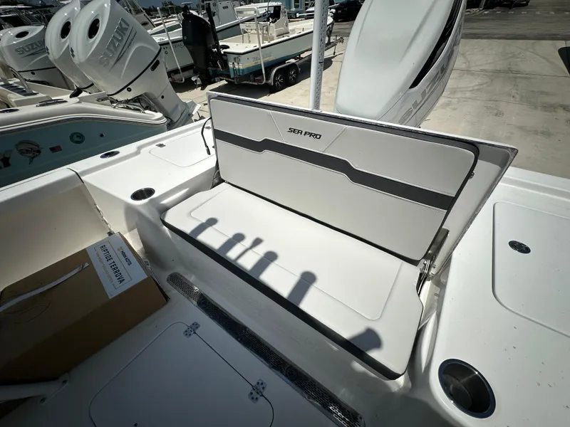 Slide: The Image of 2025 Sea Pro 250 Bay boat interior with seating and storage features. - 15