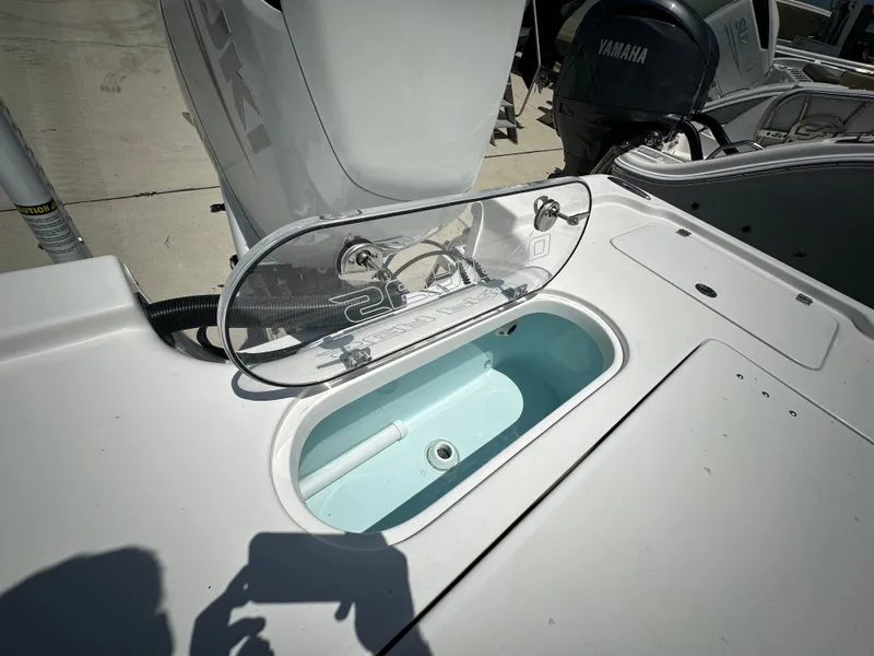 Slide: The Image of 2025 Sea Pro 250 Bay boat with open livewell and Yamaha engine in background. - 16