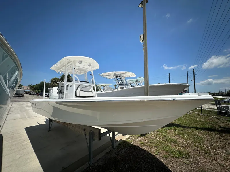 Slide: The Image of 2025 Sea Pro 250 Bay boat displayed outdoors under clear blue sky. - 2