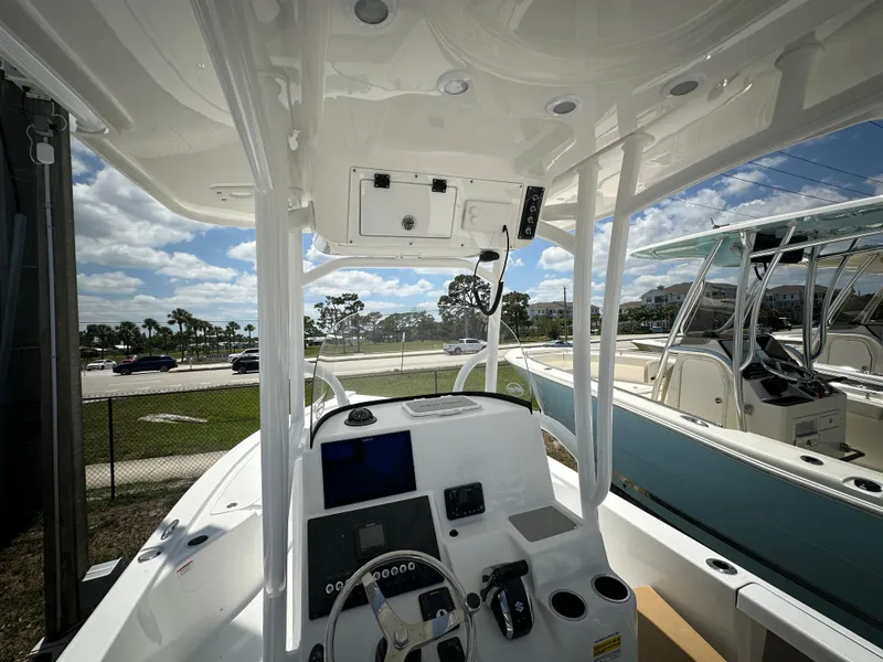 Slide: The Image of 2025 Sea Pro 250 Bay boat interior with modern dashboard and steering wheel. - 6