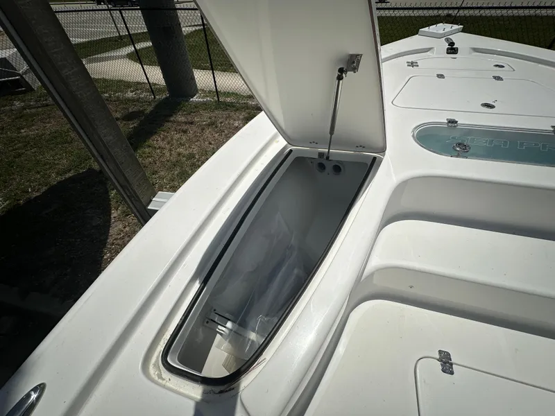 Slide: The Image of Open storage compartment on 2025 Sea Pro 250 Bay boat deck. - 8