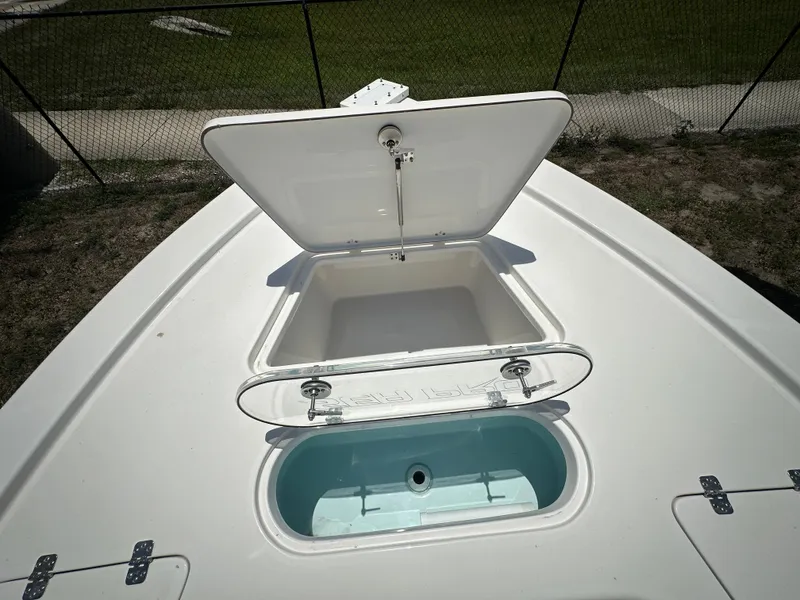 Slide: The Image of 2025 Sea Pro 250 Bay boat with open storage compartment and livewell. - 9