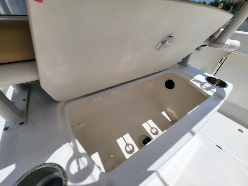 Slide: The Image of 2024 Bayliner Trophy T22CC boat storage compartment with open lid, showcasing interior space. - 14
