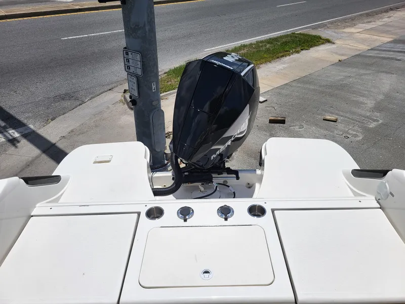 Slide: The Image of 2024 Bayliner Trophy T22CC boat with outboard motor, parked on a street. - 15