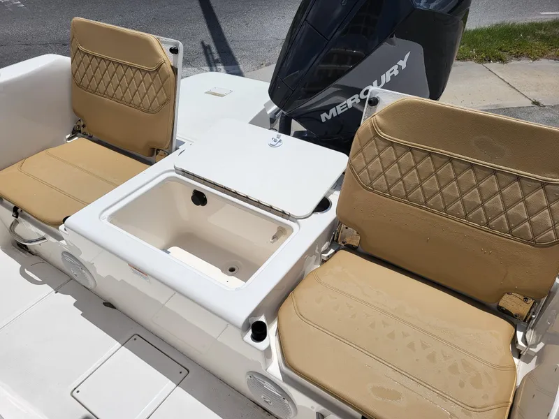 Slide: The Image of 2024 Bayliner Trophy T22CC boat seats with storage and Mercury engine. - 16