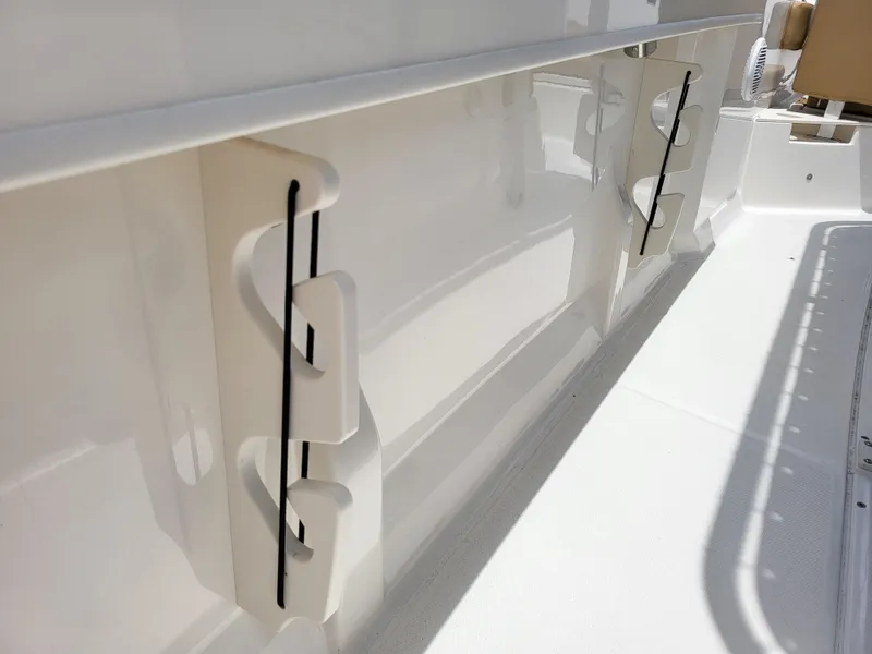 Slide: The Image of 2024 Bayliner Trophy T22CC boat interior detail with rod holders. - 17