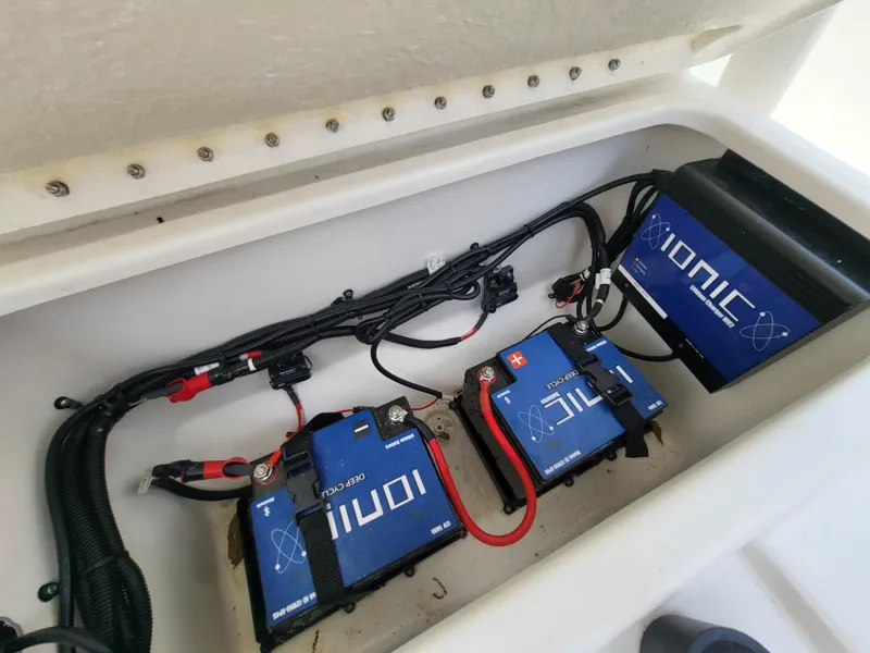 Slide: The Image of 2024 Bayliner Trophy T22CC boat battery compartment with Ionic lithium batteries. - 18