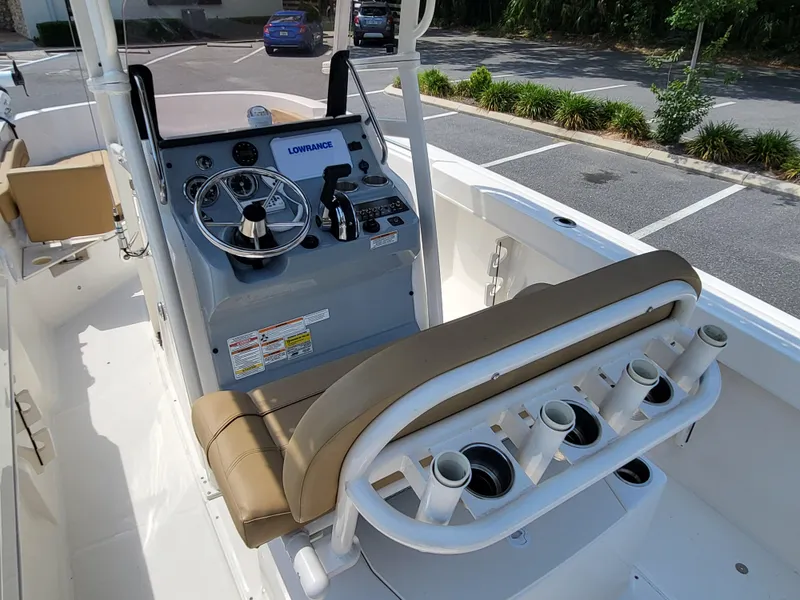 Slide: The Image of 2024 Bayliner Trophy T22CC boat console with steering wheel and rod holders. - 20