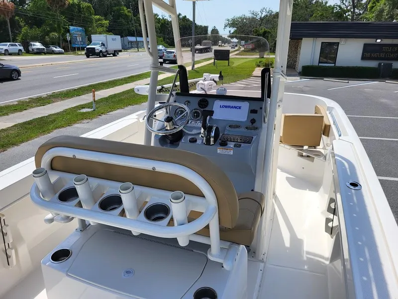 Slide: The Image of 2024 Bayliner Trophy T22CC boat interior with steering console and rod holders. - 21