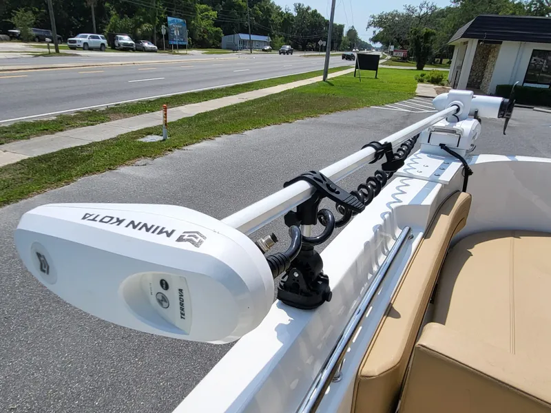 Slide: The Image of 2024 Bayliner Trophy T22CC with Minn Kota trolling motor on a sunny street. - 25