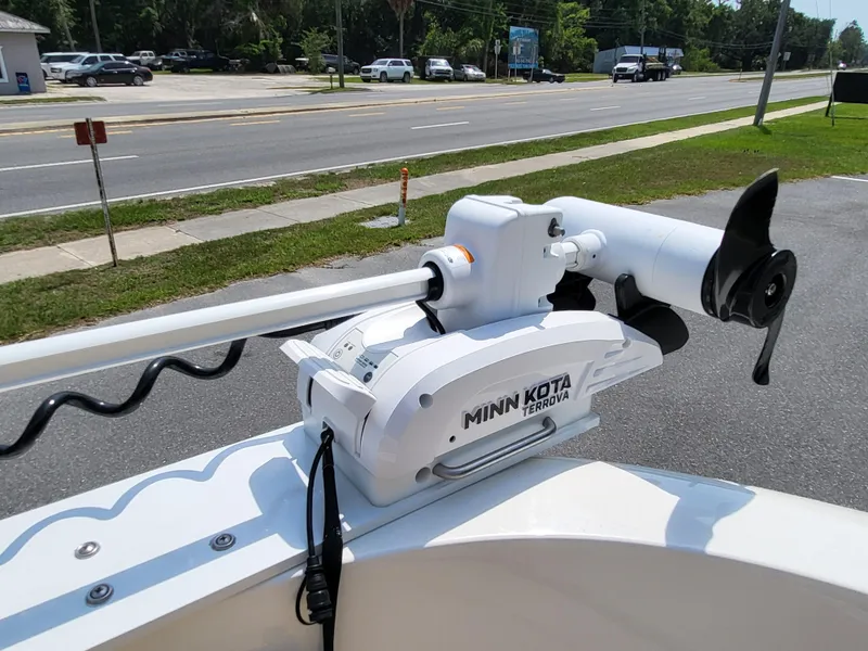 Slide: The Image of 2024 Bayliner Trophy T22CC with Minn Kota Terrova trolling motor on a sunny street. - 26