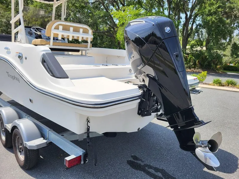 Slide: The Image of 2024 Bayliner Trophy T22CC boat on trailer with powerful outboard motor. - 4