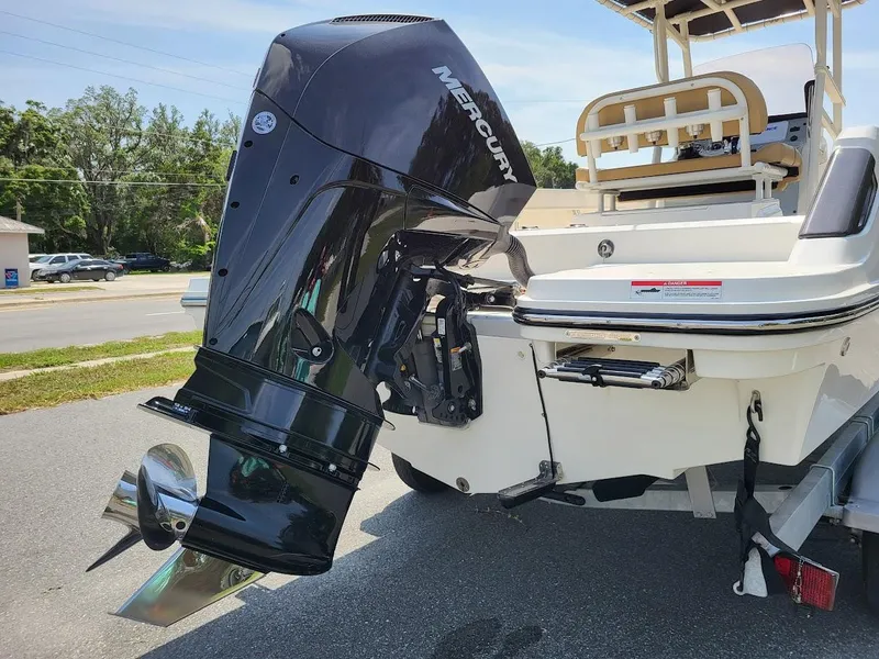 Slide: The Image of 2024 Bayliner Trophy T22CC boat with Mercury outboard motor, rear view. - 5