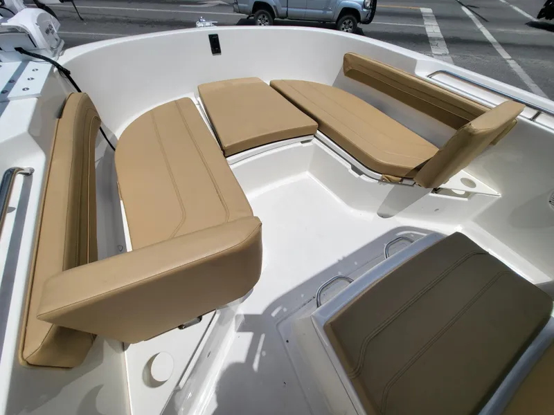 Slide: The Image of 2024 Bayliner Trophy T22CC boat interior with tan cushioned seating. - 7