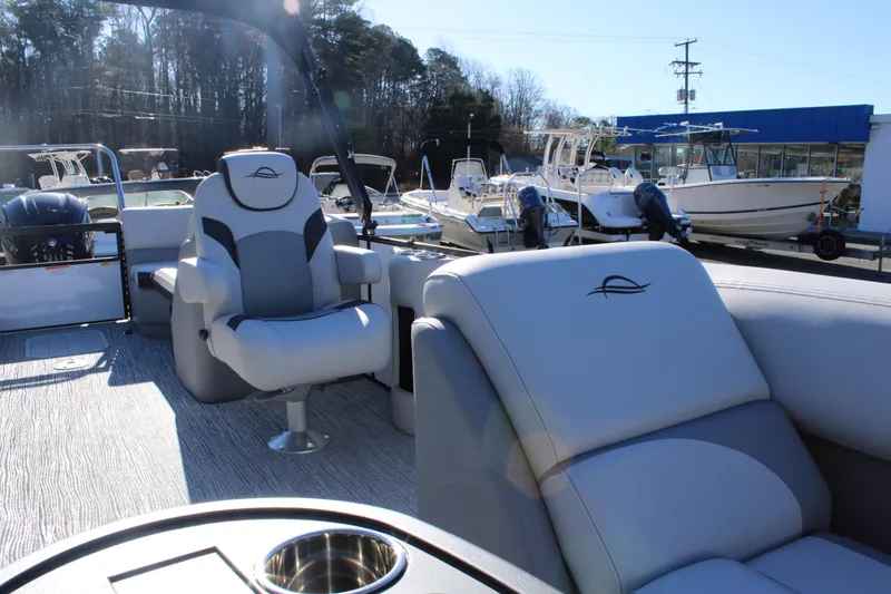 Slide: The Image of 2025 SunCatcher Select 324RC pontoon boat interior with plush seating and cup holder. - 10